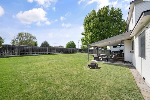 view of yard with a patio, a fire pit, and a fenced backyard