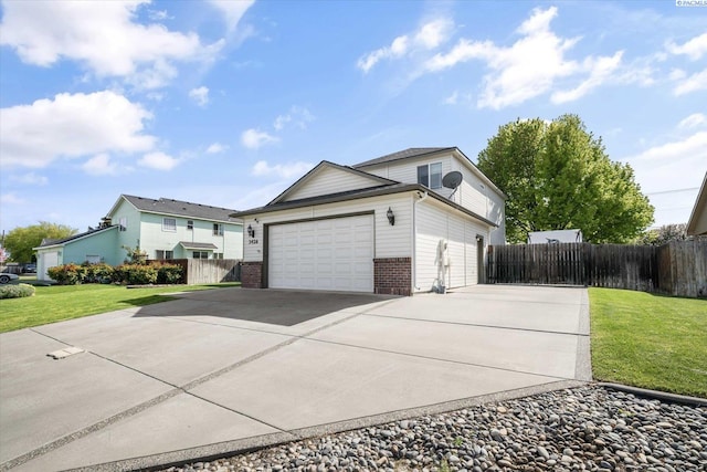 view of property exterior with a yard, driveway, brick siding, an attached garage, and fence