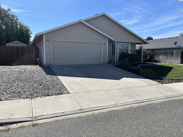 ranch-style house with a garage, driveway, and fence