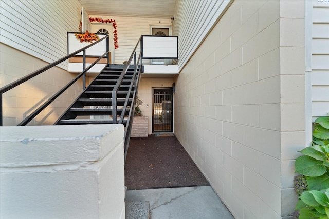 stairs featuring concrete flooring