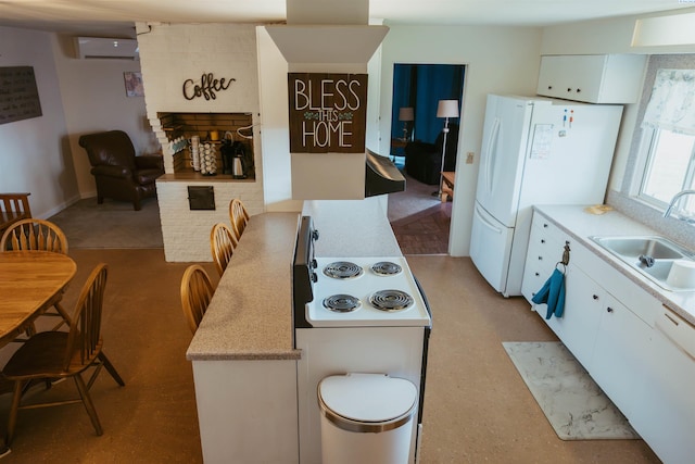 kitchen featuring white cabinetry, white appliances, sink, and an AC wall unit