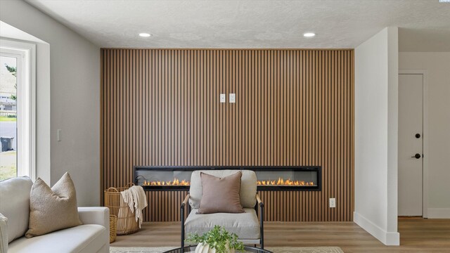 4308 S Sharron Ct, Kennewick, WA 99337 - living area featuring a glass covered fireplace, wood finished floors, healthy amount of natural light, and recessed lighting