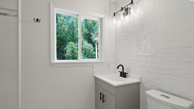 4308 S Sharron Ct, Kennewick, WA 99337 - bathroom featuring vanity, tasteful backsplash, and tile walls