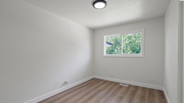 4308 S Sharron Ct, Kennewick, WA 99337 - spare room featuring light wood-style floors and a textured ceiling