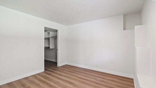 4308 S Sharron Ct, Kennewick, WA 99337 - unfurnished bedroom with light wood-style flooring, a closet, and a spacious closet