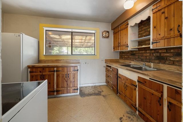 2018 W 2nd Ave, Kennewick, WA 99301 - kitchen featuring light floors, freestanding refrigerator, brown cabinets, and open shelves