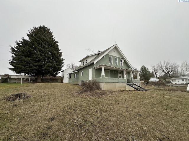 view of home's exterior with a porch and a yard