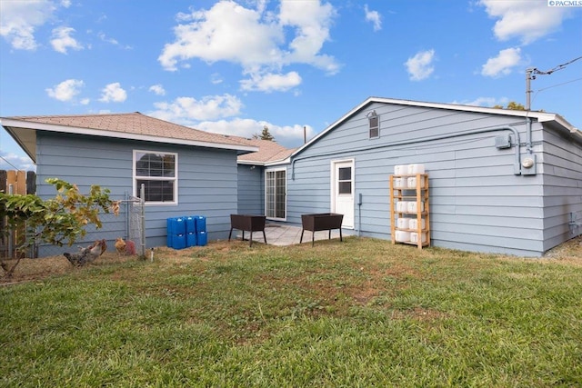 back of property featuring a yard and a patio