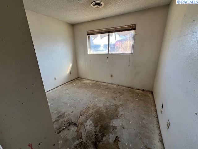 spare room with visible vents and a textured ceiling