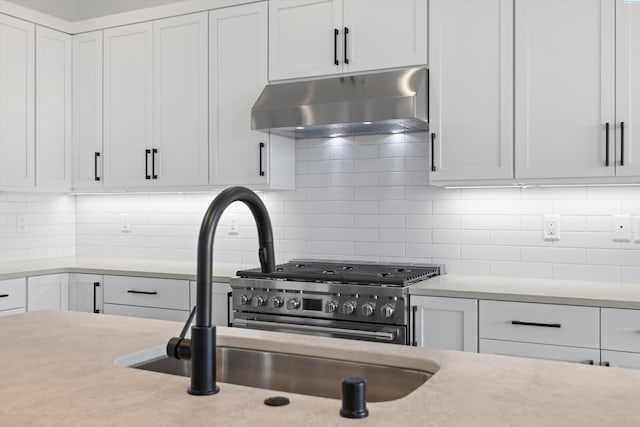 kitchen with sink, decorative backsplash, and white cabinets