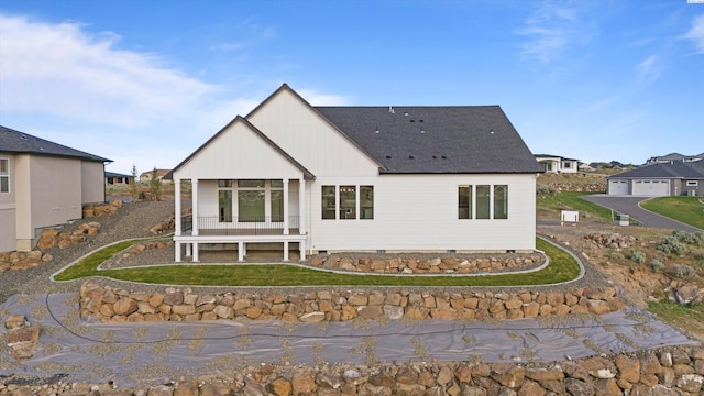 rear view of house featuring a lawn