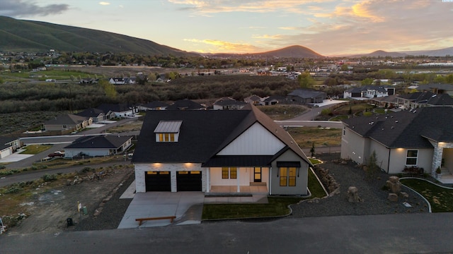 aerial view at dusk featuring a mountain view