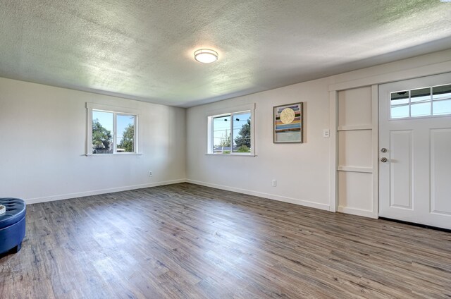 foyer entrance with hardwood / wood-style flooring and a textured ceiling