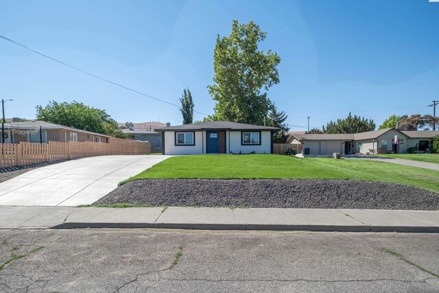 ranch-style home featuring a front yard