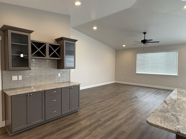 2730 Westhaven Ct, West Richland, WA 99353 - kitchen featuring a ceiling fan, baseboards, dark wood finished floors, lofted ceiling, and backsplash