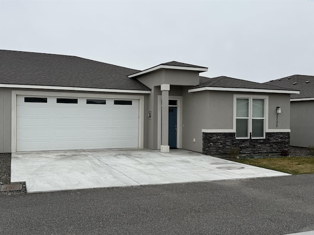 2730 Westhaven Ct, West Richland, WA 99353 - prairie-style house featuring stone siding, stucco siding, concrete driveway, and a garage