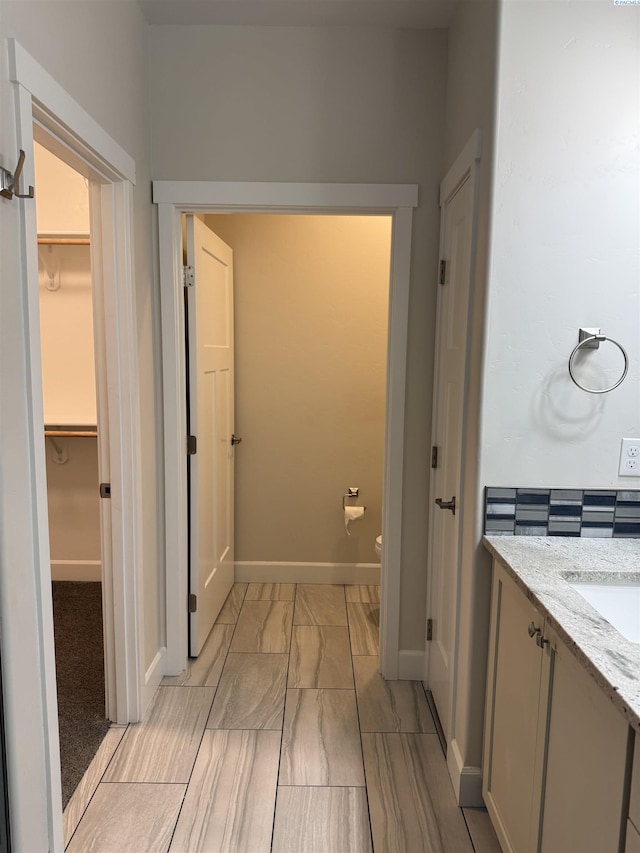 2730 Westhaven Ct, West Richland, WA 99353 - bathroom featuring toilet, vanity, a walk in closet, and baseboards