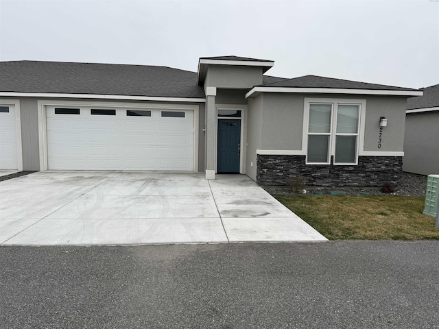 2730 Westhaven Ct, West Richland, WA 99353 - prairie-style home featuring a garage, stone siding, driveway, and stucco siding