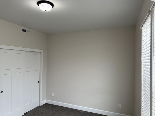2730 Westhaven Ct, West Richland, WA 99353 - unfurnished bedroom featuring visible vents, baseboards, a closet, and dark carpet