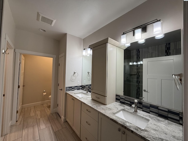 2730 Westhaven Ct, West Richland, WA 99353 - full bath featuring visible vents, backsplash, toilet, and a sink