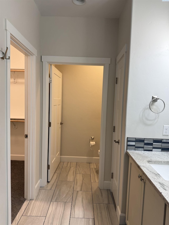 2730 Westhaven Ct, West Richland, WA 99353 - bathroom featuring a walk in closet, toilet, vanity, and baseboards