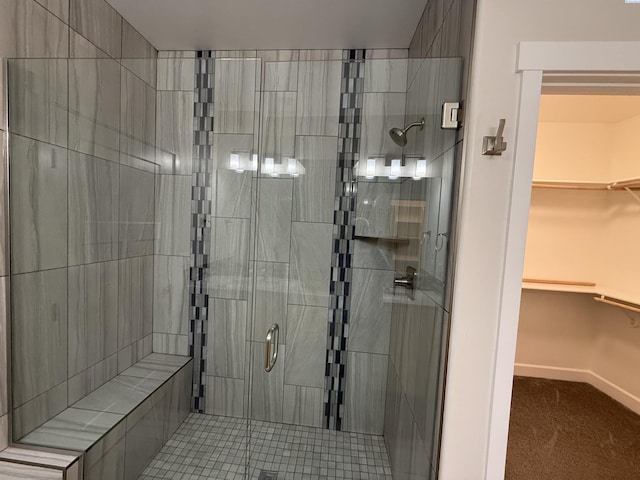 2730 Westhaven Ct, West Richland, WA 99353 - bathroom featuring a walk in closet, baseboards, and a stall shower