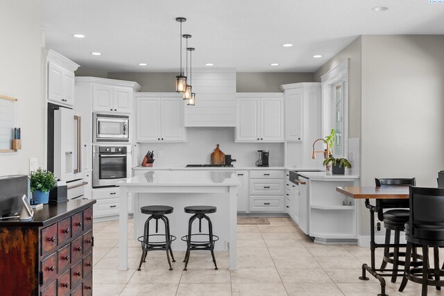 1430 Purple Sage St, Richland, WA 99352 - kitchen with appliances with stainless steel finishes, a breakfast bar, a sink, recessed lighting, and open shelves