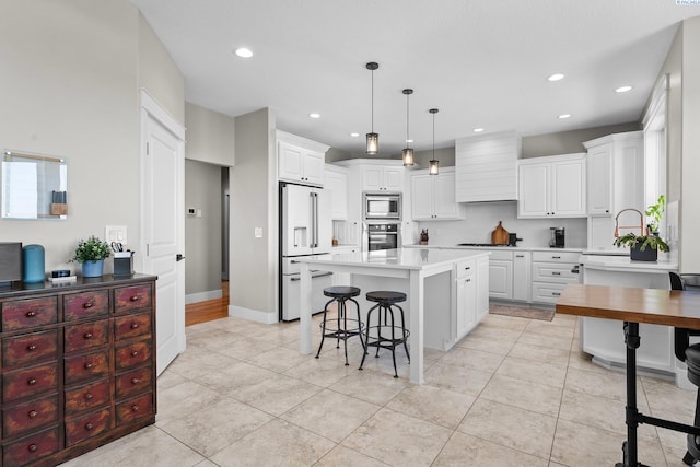 1430 Purple Sage St, Richland, WA 99352 - kitchen featuring stainless steel appliances, recessed lighting, a kitchen breakfast bar, light countertops, and a center island
