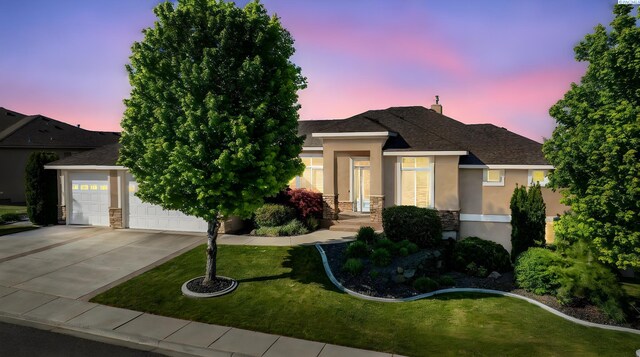 1430 Purple Sage St, Richland, WA 99352 - view of front facade featuring stucco siding, stone siding, driveway, a yard, and a garage