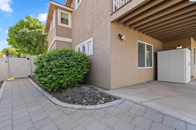 1430 Purple Sage St, Richland, WA 99352 - view of home's exterior featuring a gate, stucco siding, a patio, and fence
