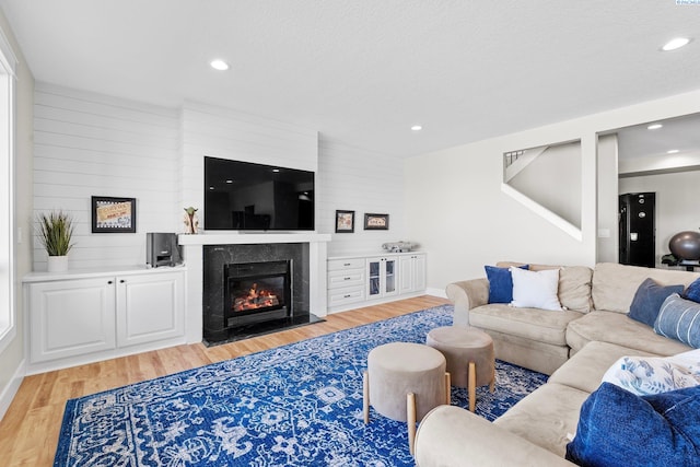 1430 Purple Sage St, Richland, WA 99352 - living area featuring light wood finished floors, a high end fireplace, recessed lighting, and baseboards