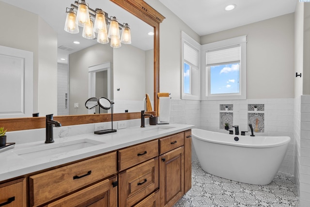 1430 Purple Sage St, Richland, WA 99352 - full bathroom with a soaking tub, double vanity, tile patterned floors, wainscoting, and tile walls