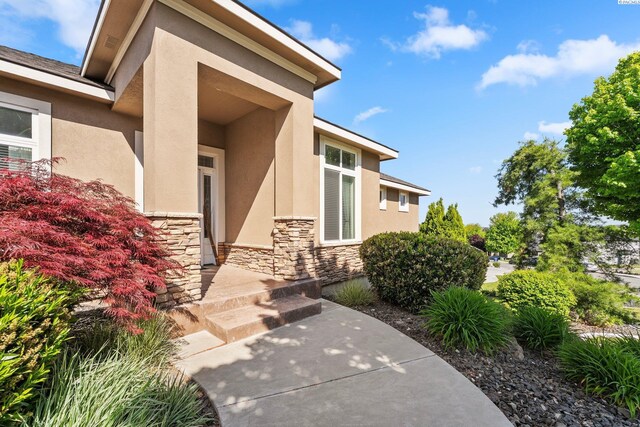 1430 Purple Sage St, Richland, WA 99352 - property entrance featuring stone siding, stucco siding, and a patio