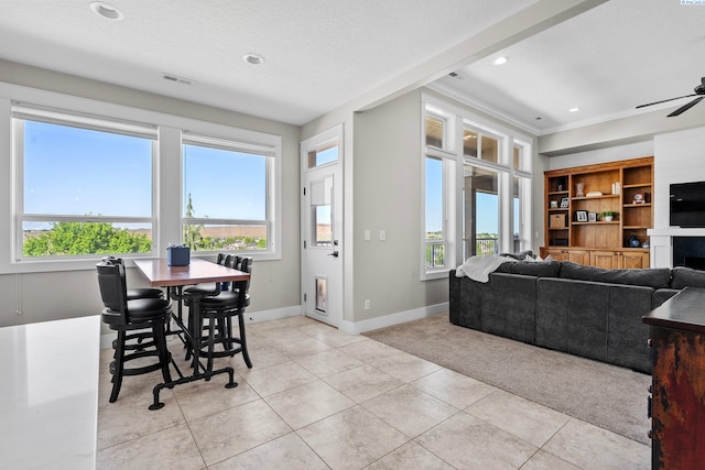 1430 Purple Sage St, Richland, WA 99352 - dining room featuring light carpet, baseboards, crown molding, ceiling fan, and light tile patterned floors