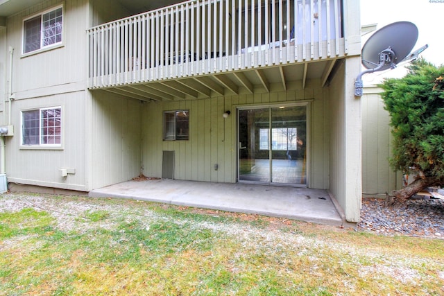 rear view of property with a patio and a balcony