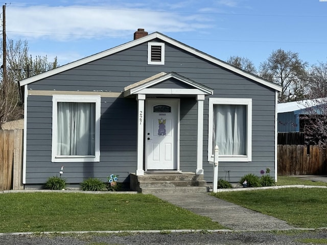 227 E 5th Ave, Kennewick, WA 99336 - bungalow-style house featuring fence, a chimney, and a front yard