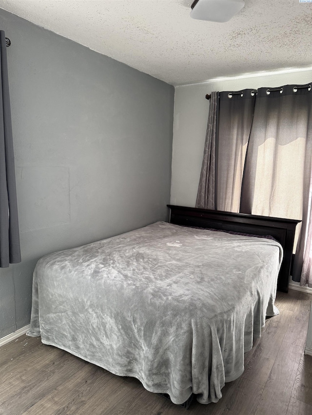 227 E 5th Ave, Kennewick, WA 99336 - bedroom with baseboards, a textured ceiling, and wood finished floors