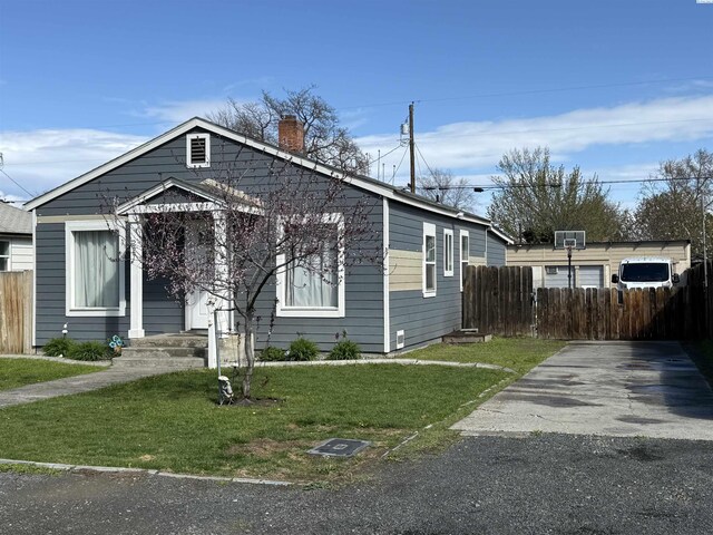227 E 5th Ave, Kennewick, WA 99336 - bungalow with a front lawn, fence, and a chimney