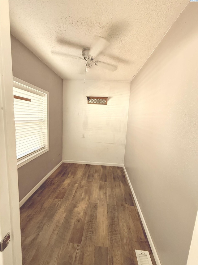 227 E 5th Ave, Kennewick, WA 99336 - unfurnished room with baseboards, a ceiling fan, a textured ceiling, and wood finished floors
