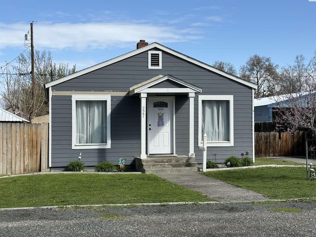 227 E 5th Ave, Kennewick, WA 99336 - bungalow-style house with a front lawn, fence, and a chimney