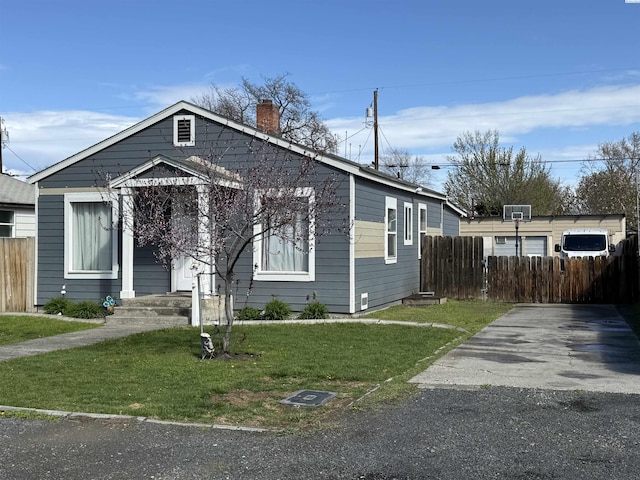 227 E 5th Ave, Kennewick, WA 99336 - bungalow-style home featuring fence, a chimney, and a front yard