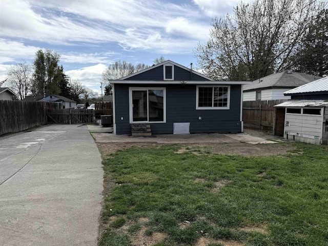 227 E 5th Ave, Kennewick, WA 99336 - rear view of property with a lawn, a fenced backyard, a patio area, and cooling unit