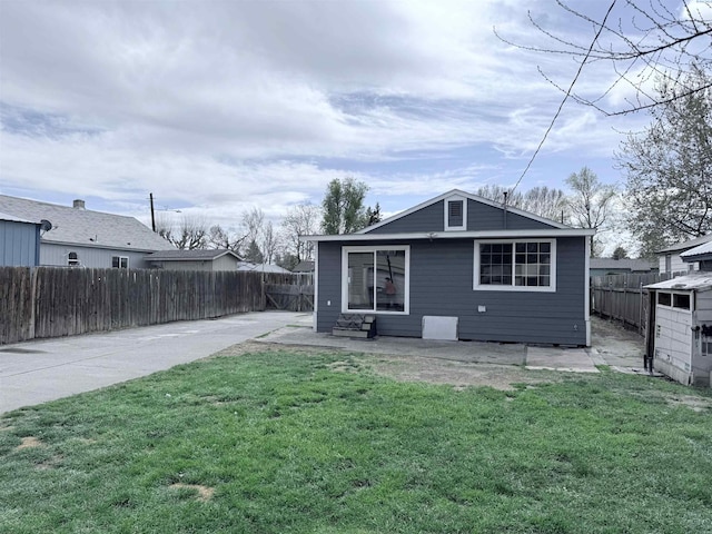 227 E 5th Ave, Kennewick, WA 99336 - rear view of property featuring a lawn, a fenced backyard, and a patio area