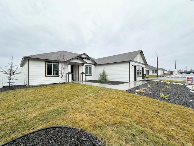 view of front of home with a garage and a front lawn