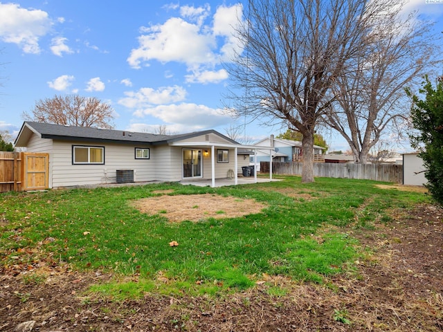 back of property with a patio, a yard, and central AC unit