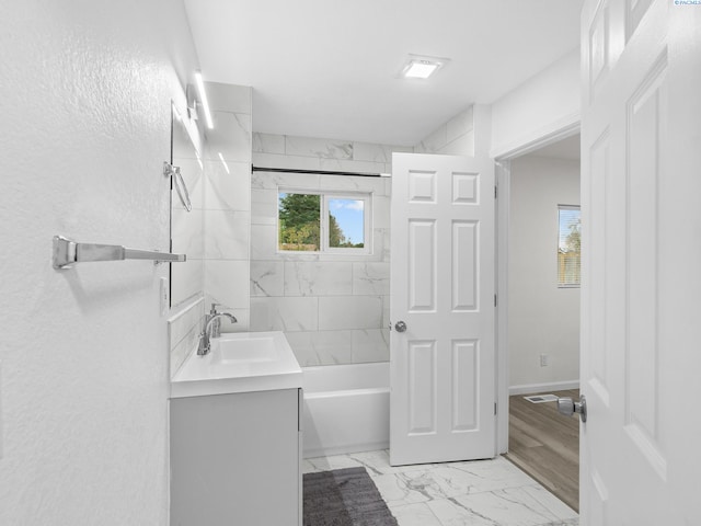 bathroom with vanity and tiled shower / bath combo