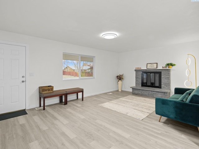 living room with a fireplace and light hardwood / wood-style flooring