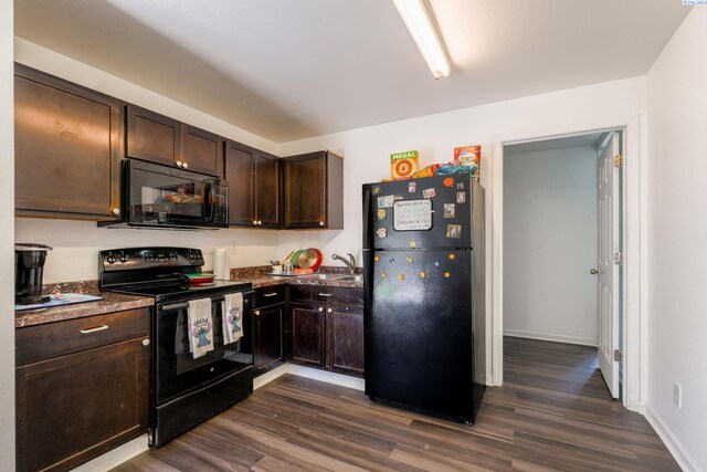 742 E 4th Ave, Kennewick, WA 99336 - kitchen featuring black appliances, dark wood-style floors, dark brown cabinetry, and dark countertops