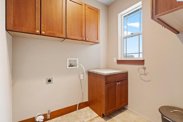 clothes washing area featuring electric dryer hookup, hookup for a washing machine, and cabinets