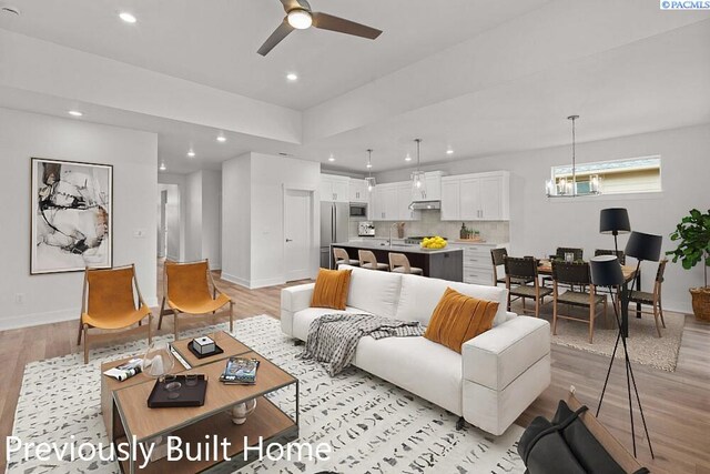 12113 Dunsmuir Dr, Pasco, WA 99301 - living room with baseboards, ceiling fan with notable chandelier, light wood-type flooring, and recessed lighting